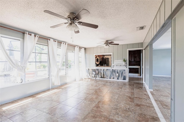 unfurnished sunroom featuring visible vents