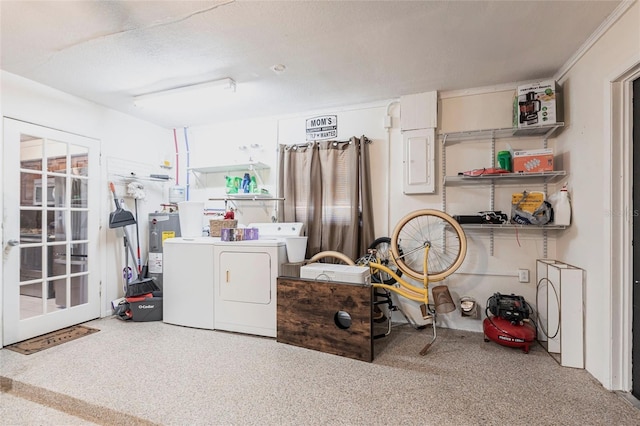 clothes washing area with electric water heater, independent washer and dryer, and laundry area