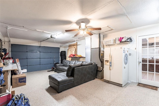 garage with white refrigerator with ice dispenser and a ceiling fan