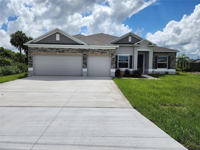 view of front of property with stucco siding, driveway, stone siding, a front yard, and a garage