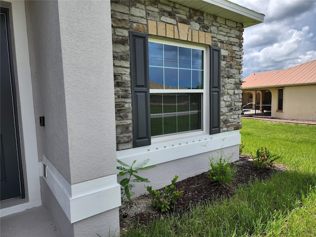 exterior space featuring stone siding and stucco siding