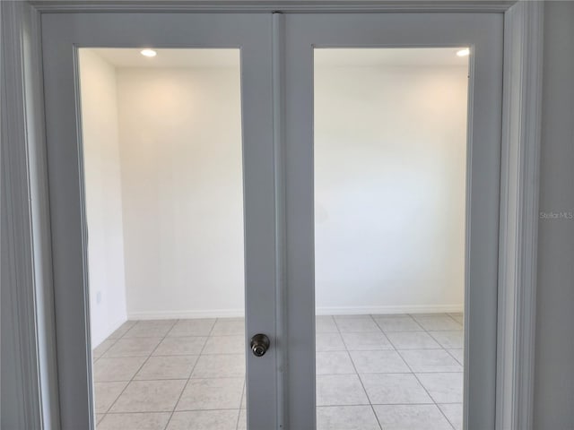 interior space with light tile patterned floors and baseboards