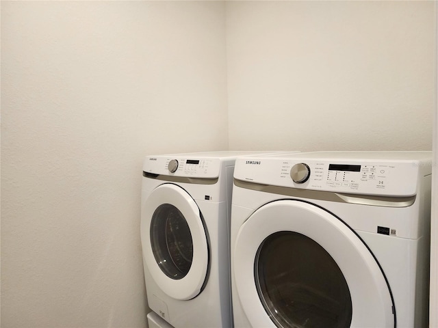 washroom featuring laundry area and washing machine and clothes dryer