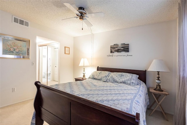 bedroom with visible vents, carpet flooring, a closet, a textured ceiling, and a ceiling fan