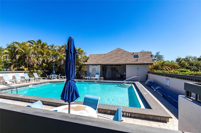 pool with a patio and fence