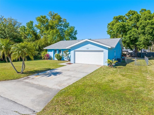 ranch-style home featuring a front lawn, fence, central air condition unit, concrete driveway, and an attached garage