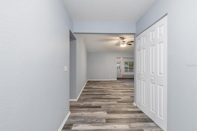 hall with wood finished floors and baseboards