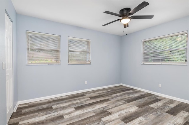 unfurnished room with ceiling fan, baseboards, and wood finished floors