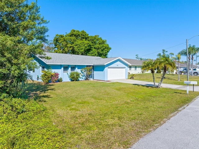 single story home with driveway, a front yard, and a garage