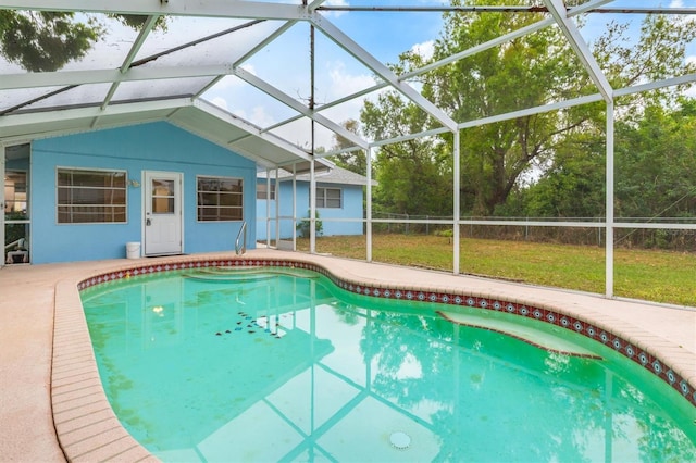 pool featuring glass enclosure and a patio