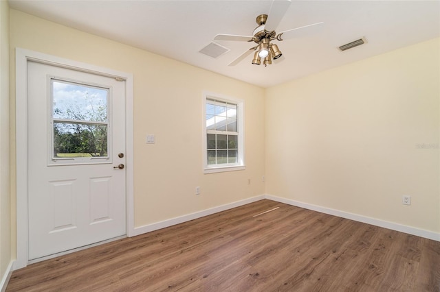 doorway featuring visible vents, plenty of natural light, and wood finished floors