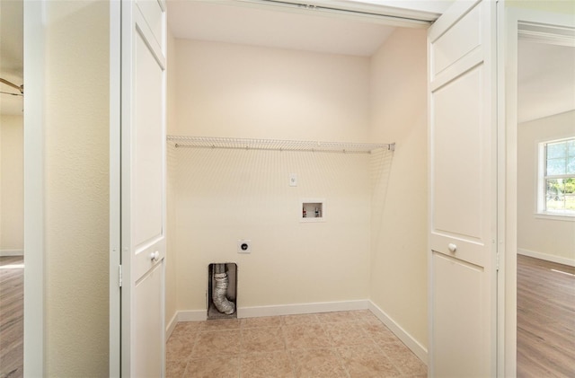 washroom with hookup for a washing machine, baseboards, laundry area, light tile patterned flooring, and electric dryer hookup