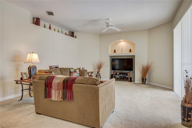 living room with baseboards, light carpet, visible vents, and ceiling fan