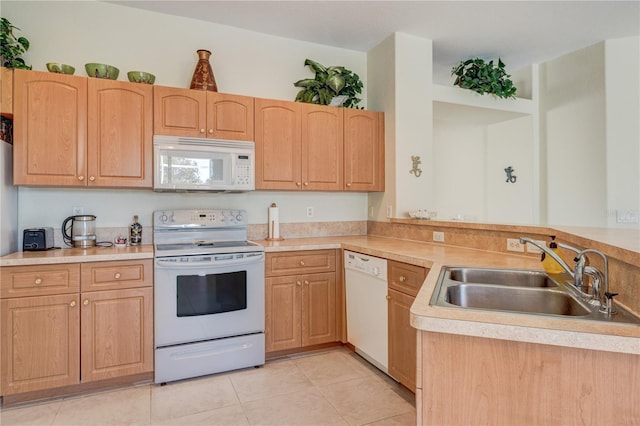 kitchen featuring a sink, white appliances, and light brown cabinetry