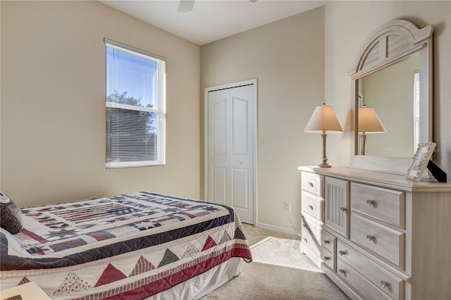 carpeted bedroom featuring baseboards, a closet, and ceiling fan