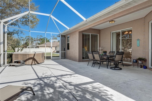 view of patio / terrace featuring outdoor dining space, a lanai, and a hot tub