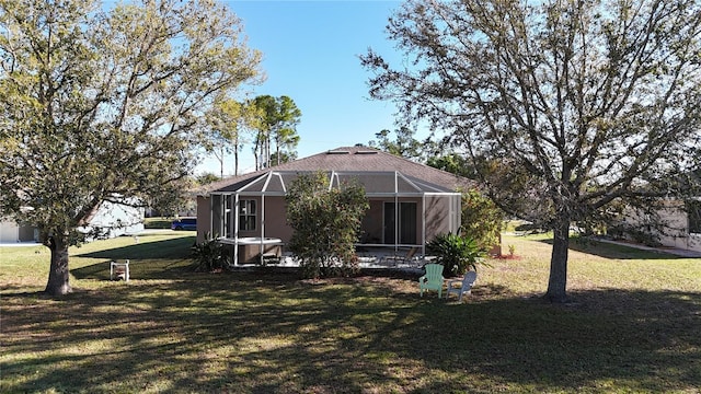 back of house featuring a lanai, a lawn, and a patio area