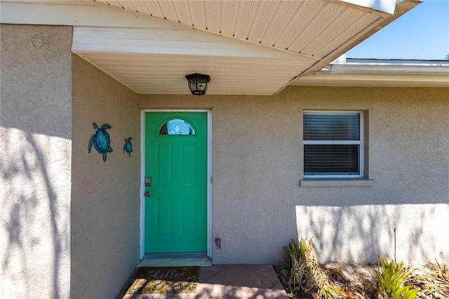 property entrance featuring stucco siding