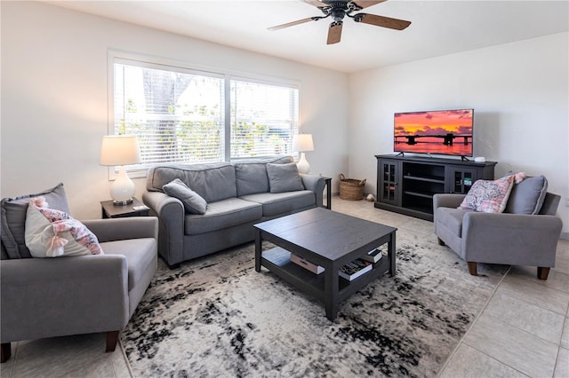 living area with light tile patterned floors and a ceiling fan