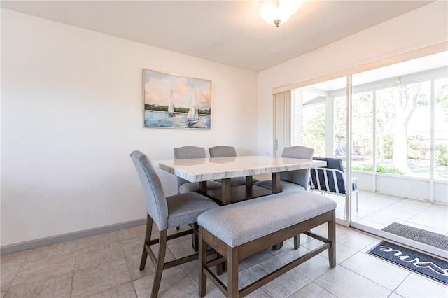 dining area with light tile patterned floors and baseboards