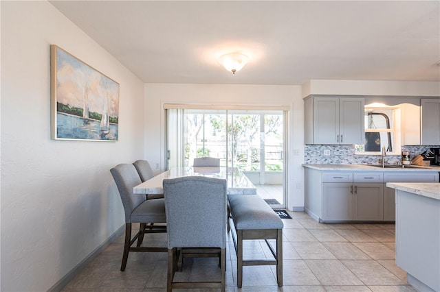 dining room with light tile patterned floors and baseboards