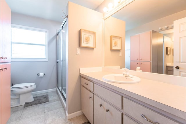 bathroom featuring toilet, a stall shower, vanity, and tile patterned flooring