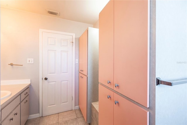 bathroom with tile patterned flooring, visible vents, and vanity