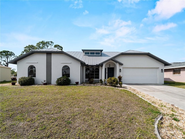 view of front of home with driveway, a standing seam roof, an attached garage, a front lawn, and metal roof