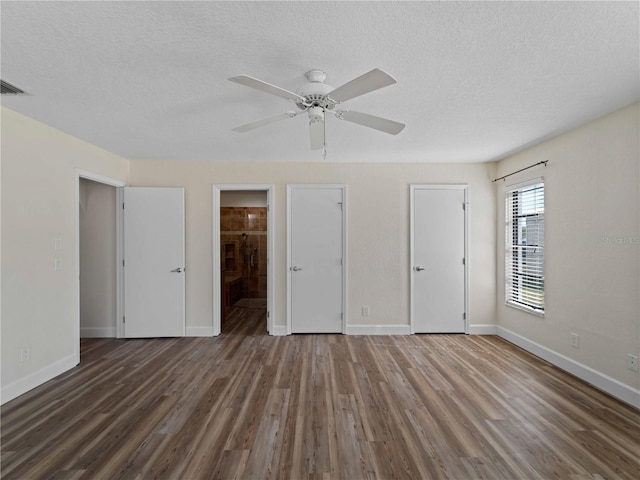 unfurnished bedroom with visible vents, wood finished floors, baseboards, and a textured ceiling