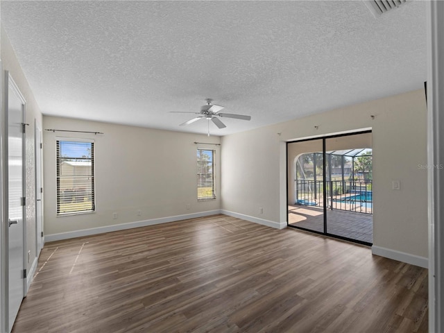 unfurnished room featuring wood finished floors, baseboards, and ceiling fan