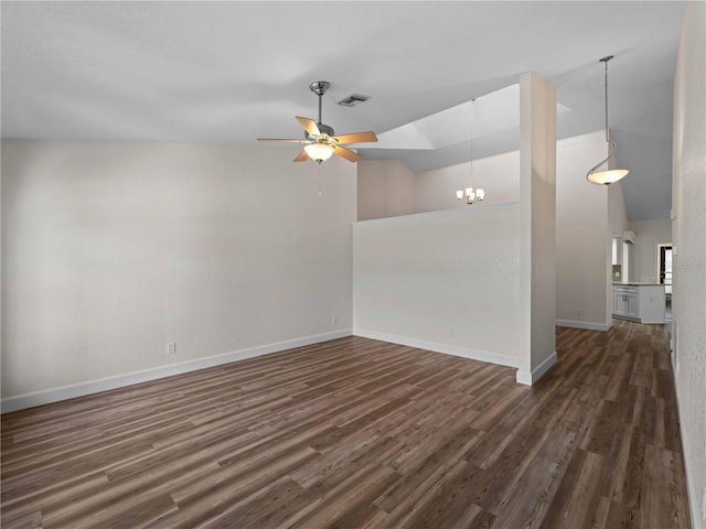 unfurnished room with visible vents, ceiling fan with notable chandelier, dark wood-type flooring, and baseboards