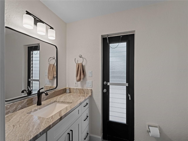 bathroom featuring plenty of natural light and vanity