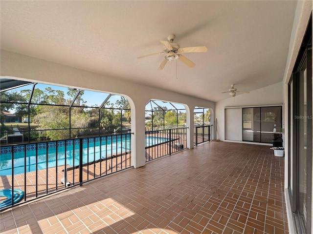 unfurnished sunroom featuring vaulted ceiling and ceiling fan