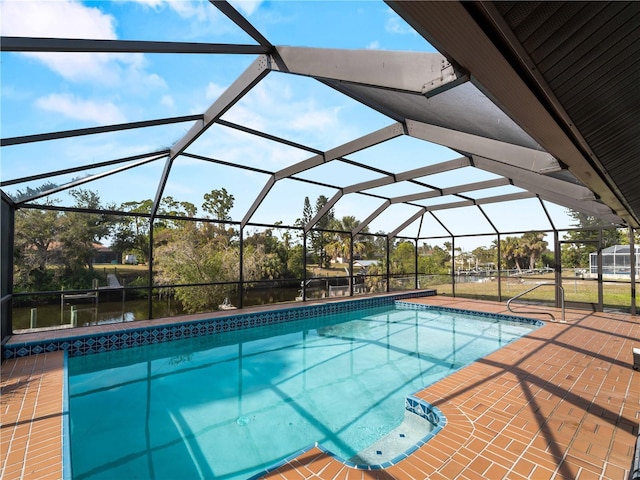 pool featuring glass enclosure and a patio