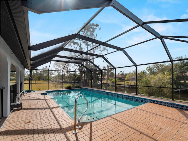 outdoor pool featuring a lanai and a patio area