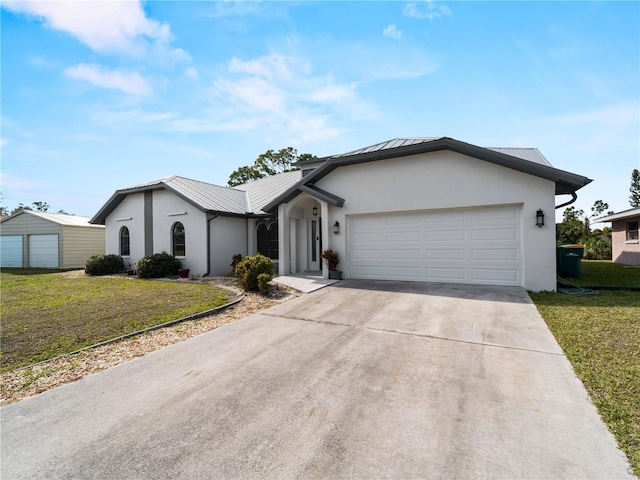 ranch-style home with stucco siding, metal roof, a garage, and a front yard