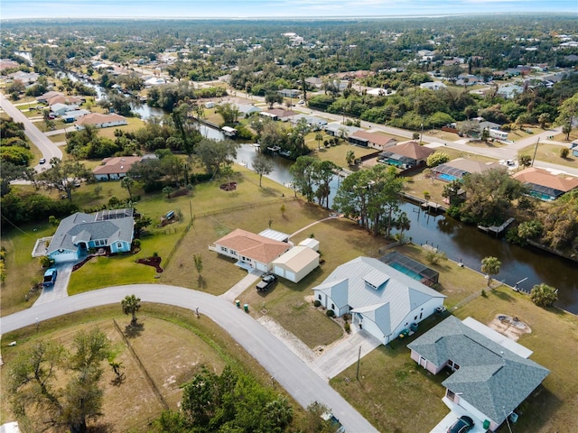 birds eye view of property with a residential view and a water view