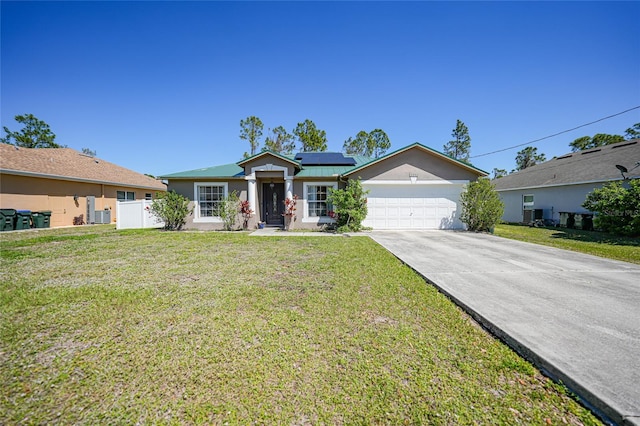 view of front of house with stucco siding, a front lawn, concrete driveway, a garage, and solar panels