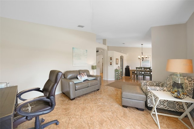 office space with arched walkways, visible vents, baseboards, and an inviting chandelier