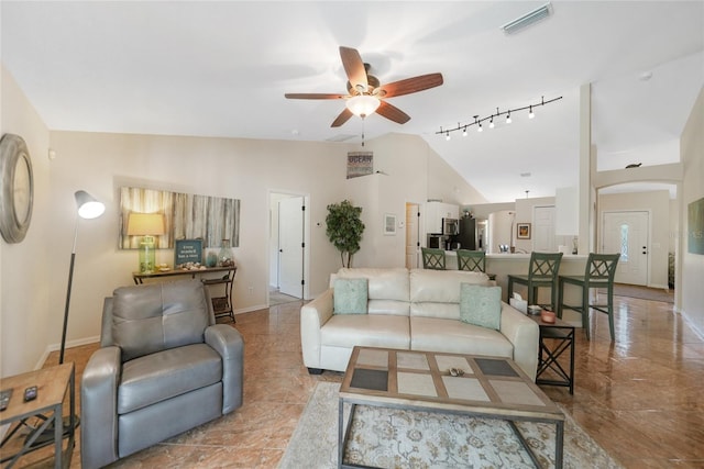 living area with lofted ceiling, a ceiling fan, visible vents, and baseboards