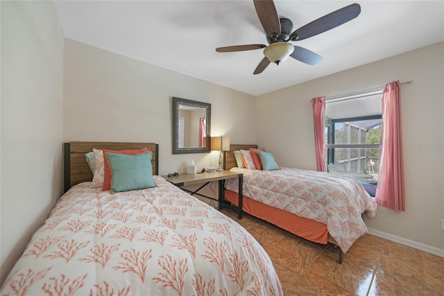 bedroom with a ceiling fan and baseboards