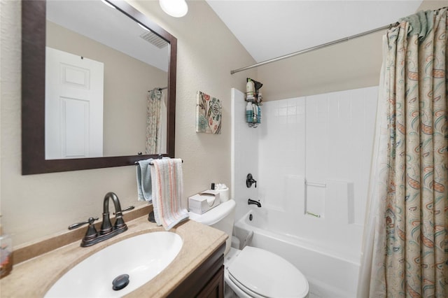 bathroom featuring vanity, shower / bath combination with curtain, toilet, and a textured wall