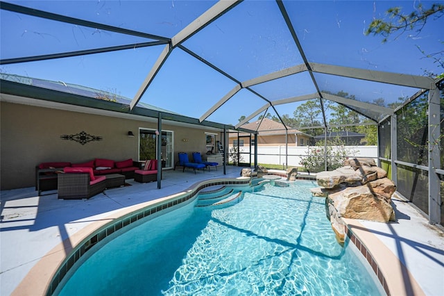 view of pool featuring an outdoor living space, glass enclosure, a patio, and a fenced in pool