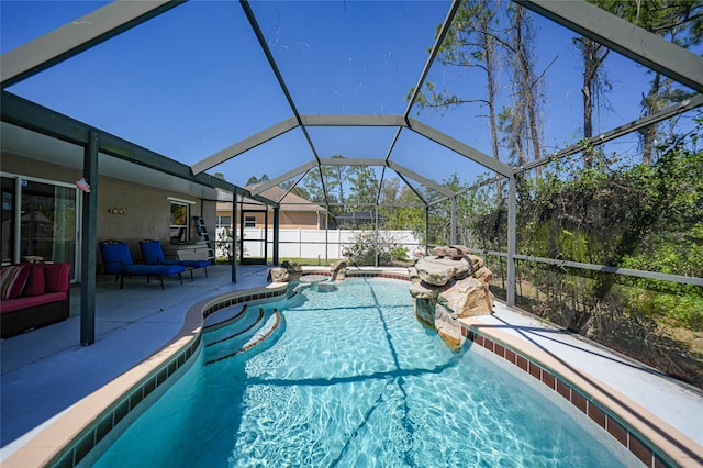 view of swimming pool with glass enclosure, a patio, and a fenced in pool