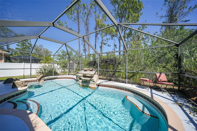 view of swimming pool featuring a fenced in pool and glass enclosure