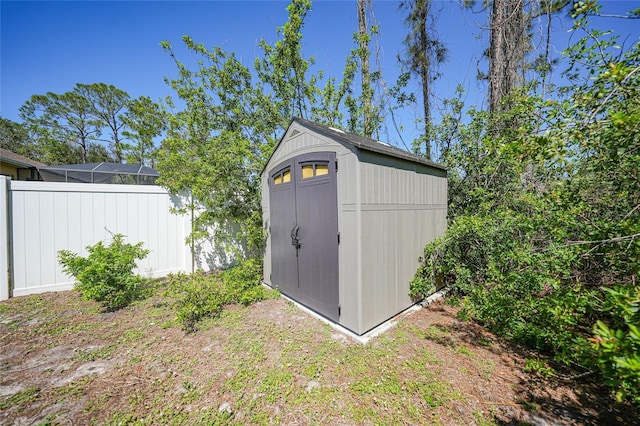 view of shed with fence