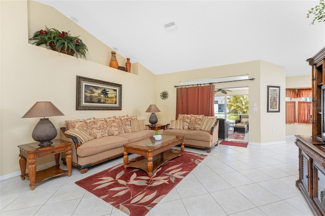 living area featuring lofted ceiling, light tile patterned floors, and baseboards