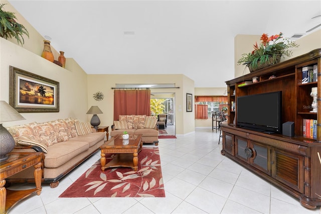 living area featuring baseboards, high vaulted ceiling, and light tile patterned flooring