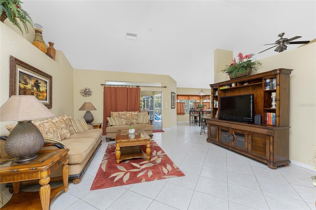 living room featuring visible vents, ceiling fan, baseboards, vaulted ceiling, and light tile patterned floors