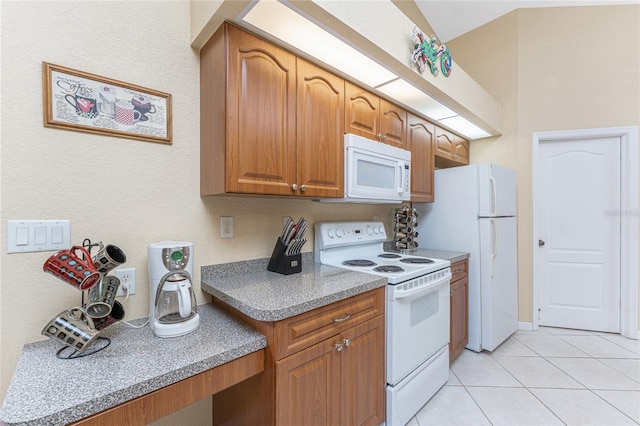 kitchen featuring white appliances, light tile patterned floors, brown cabinetry, and light countertops